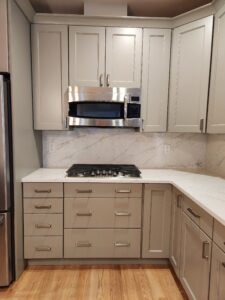 Kitchen renovation with tile counters and backsplash.